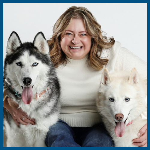 5x5 blue border Melissa Knicely white sweater two huskies either side of her