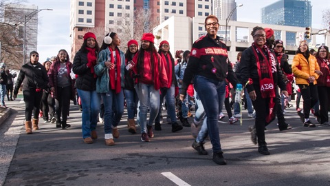 A group of people march down the street during Charlotte's MLK parade.