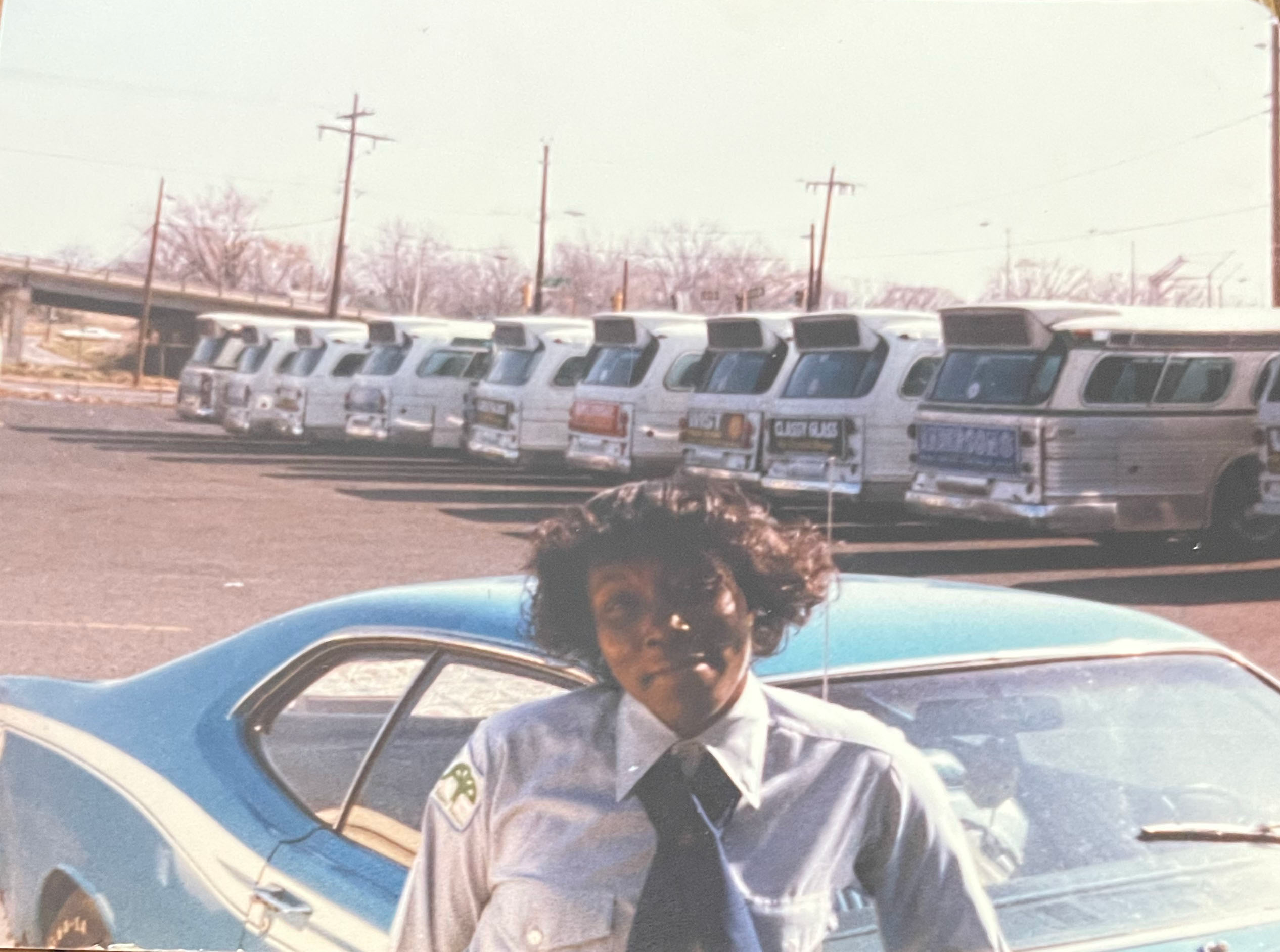 Brenda Moore posing in front of the CATS bus lot