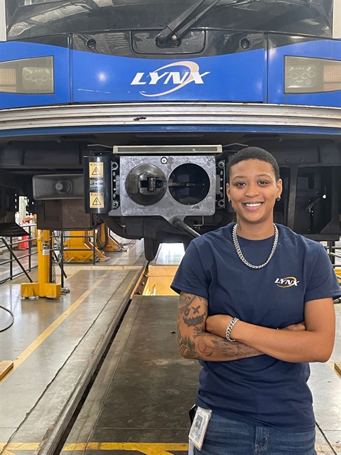 Apprentice Ja’Kiya Brown, standing infront of a CATS rail