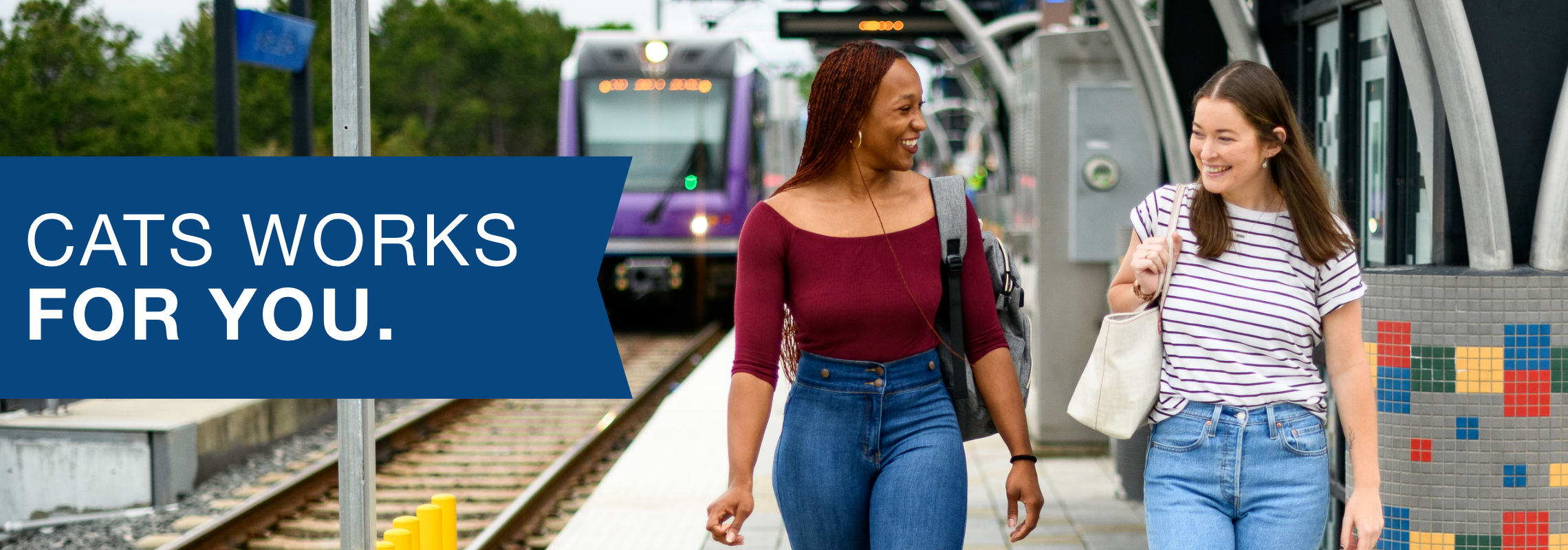 CATS works for you sentence in front of a picture of two women walking alongside rail platform