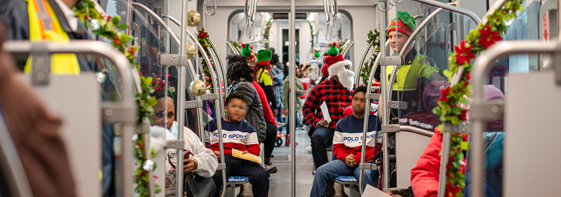 CATS LYNX Blue Line Train set up for the Holiday Express Train with people on the train. 