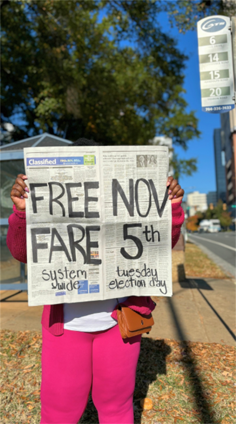 CATS rider holding a news paper that says free fare services