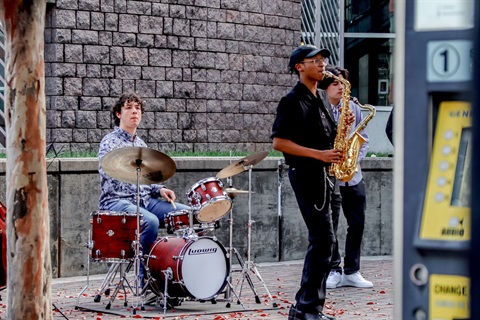 Musicians performing at a CATS rail station