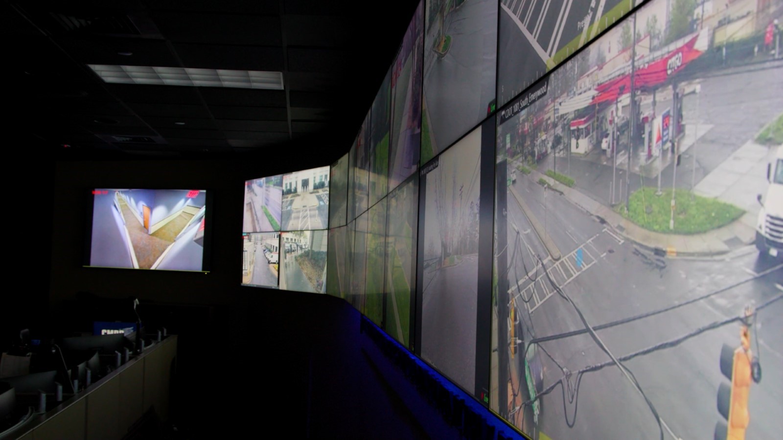 several tv screens showing live feed of streets