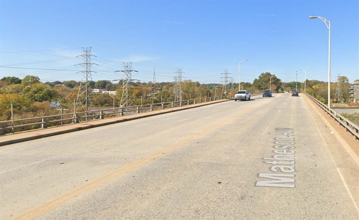 street view of existing roadway and bridge, which contains two travel lanes and no bike lanes or pedestrian path