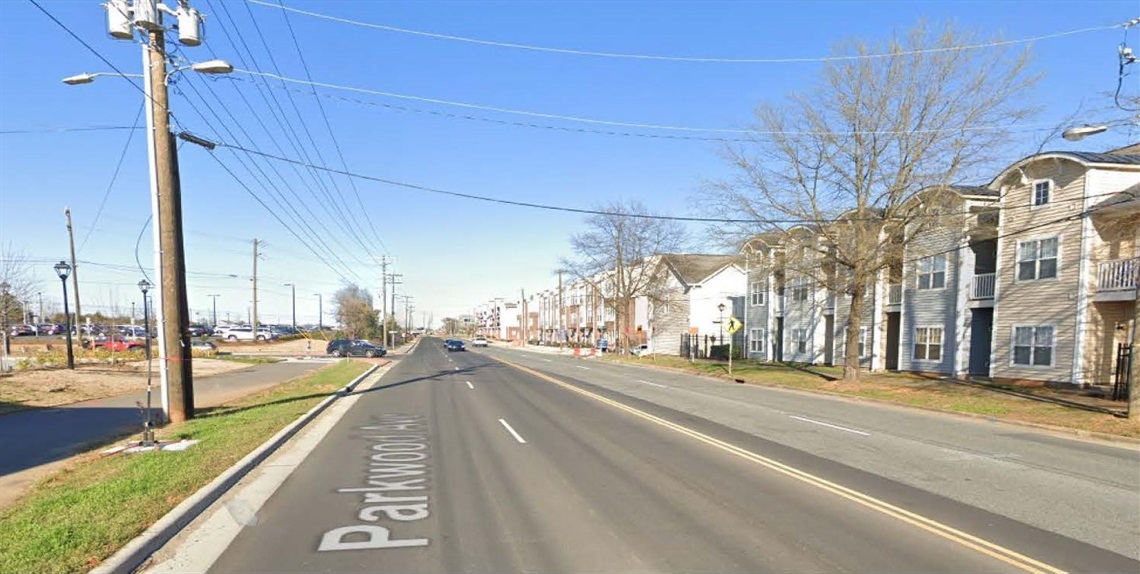 a street view of the existing street with two lanes on either side and sidewalk on one side only