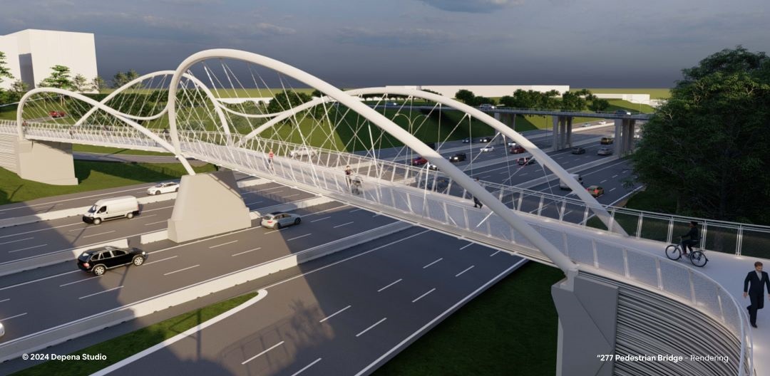 View of bridge from above and to the side, featuring two large undulating spans on both sides of the bridge with pedestrians traveling over it