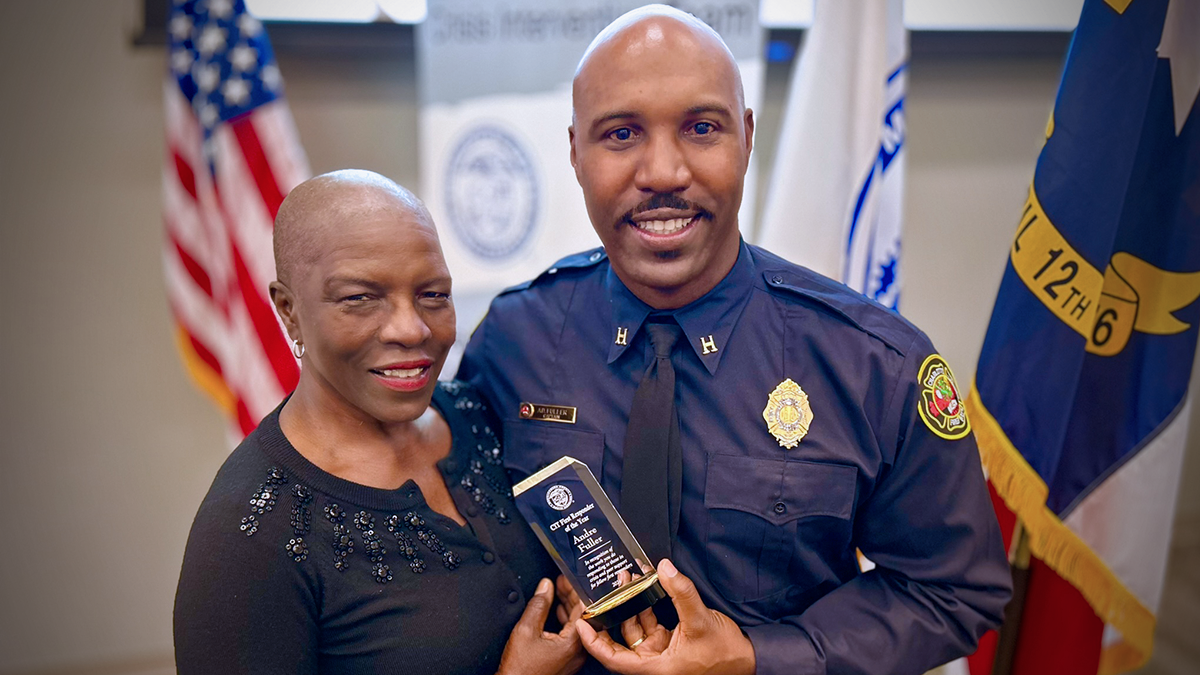 Captain Andre Fuller stands proudly with his mother, Betty Fuller, after receiving the First Responder Award at this morning's ceremony. Their shared moment celebrates his dedication to mental health advocacy and the support system that has inspired his work.