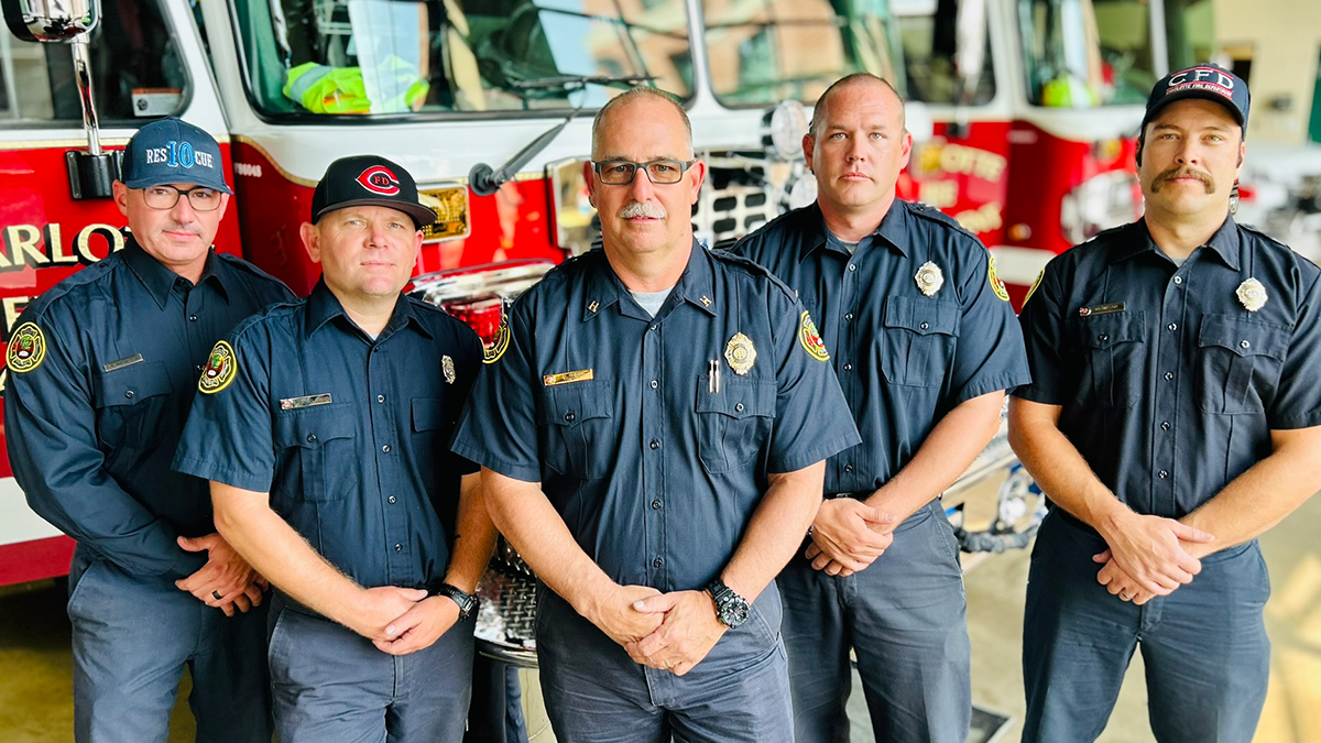 Captain Jeff Bright (center) stands proudly with his Rescue 10 crew at Firehouse 10, Charlotte, NC. Known for his calm leadership and extensive expertise in rescue operations, Captain Bright has earned the trust and admiration of his team, who follow his lead without hesitation. Pictured left to right: Engineer Bill Mitchell, Engineer Jonathan Belcher, Capt. Jeff Bright, Firefighter Kevin Murphy, Firefighter William Mason. 