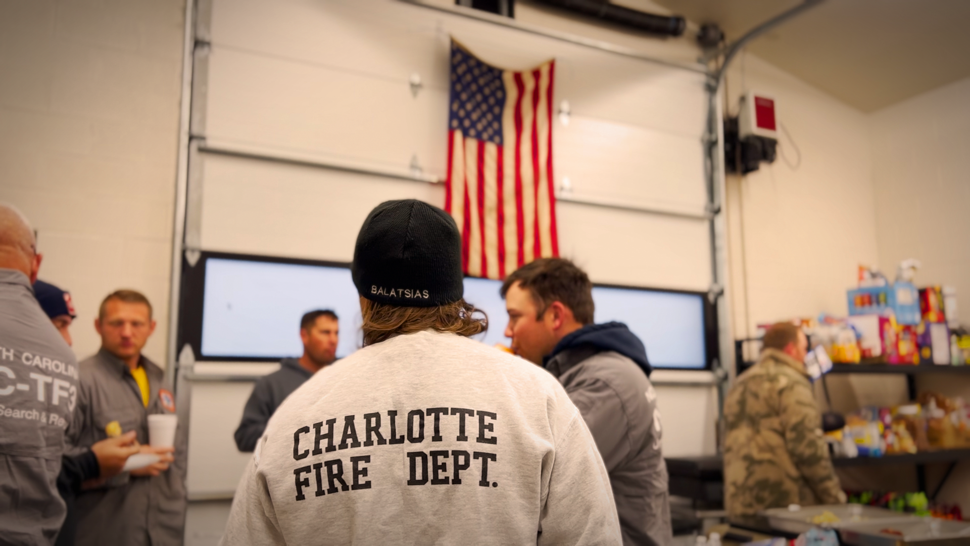 Under the American flag, Charlotte Fire crews fuel up with breakfast before heading out for another day of recovery efforts in Yancey County, continuing their unwavering mission to support the community after Hurricane Helene.