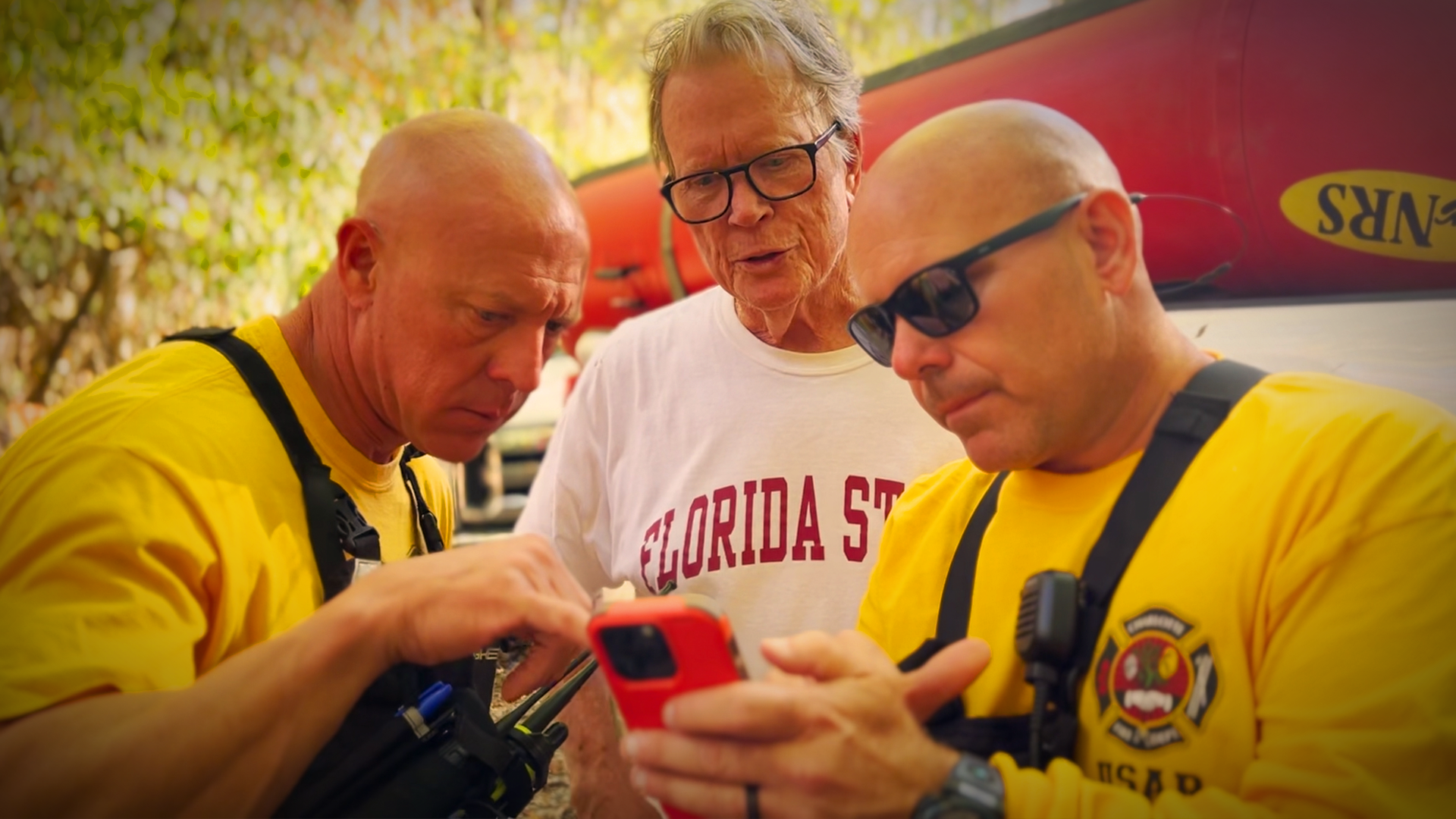 Captains Steven Pritchard and Matthew Harrington review information shared by a Yancey County resident who points out potential areas where the team may find a missing individual.