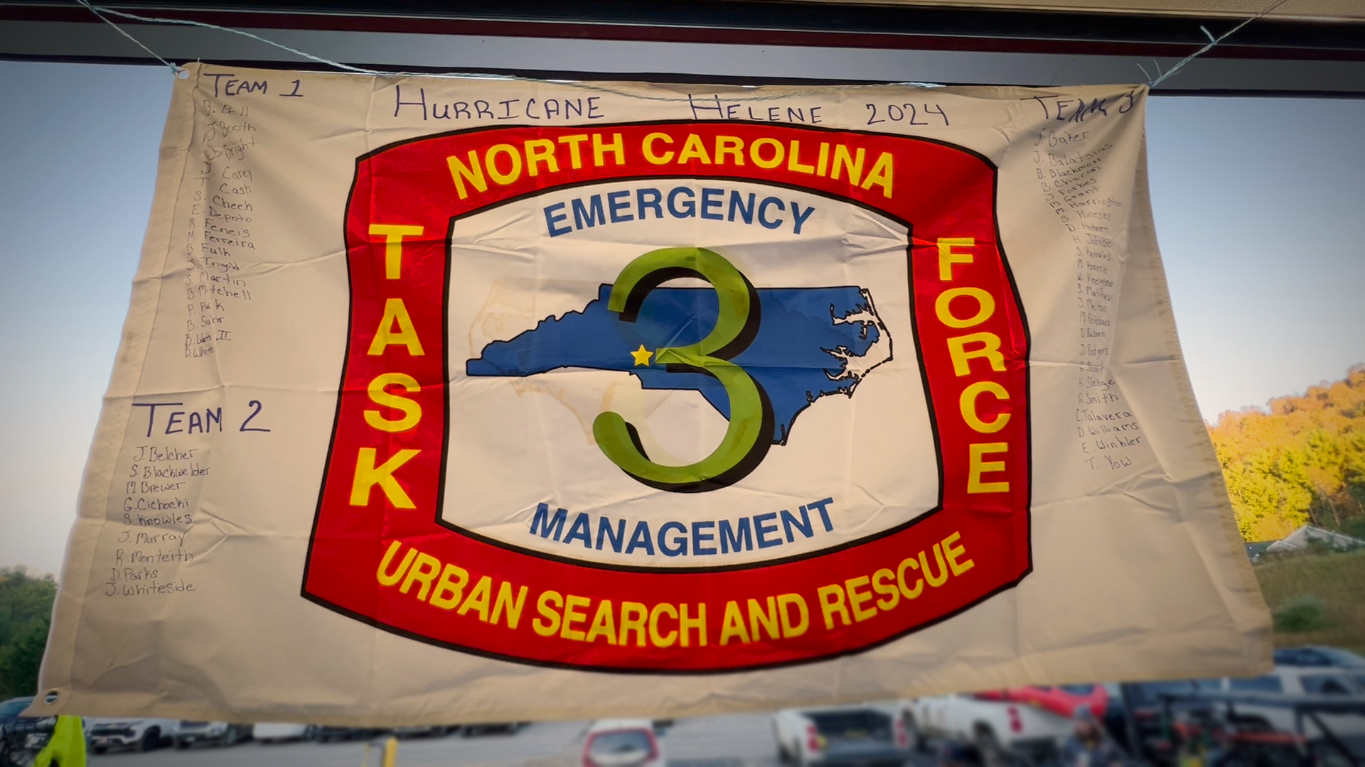 The Task Force 3 flag, bearing the names of Charlotte Fire's crew members, symbolizes their unity and dedication to helping those affected by Hurricane Helene.