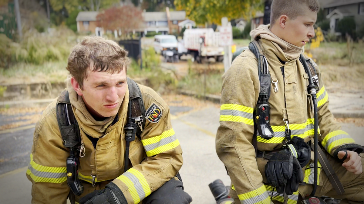 Charlotte Fire recruits take a moment to regroup, reflecting the physical demands and dedication required in training. 