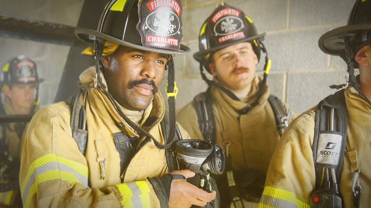 Charlotte Fire recruit Eli Basnight, centered, focuses intently during a training exercise, embodying dedication and resilience as he prepares to serve his hometown. His determination reflects the commitment of every recruit at the Charlotte Fire Training Academy. 