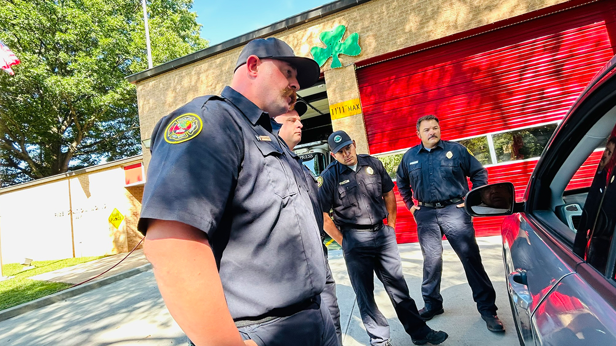 The Firehouse 15 crew stands outside the home of Engine 15 “The Shamrock Express” 