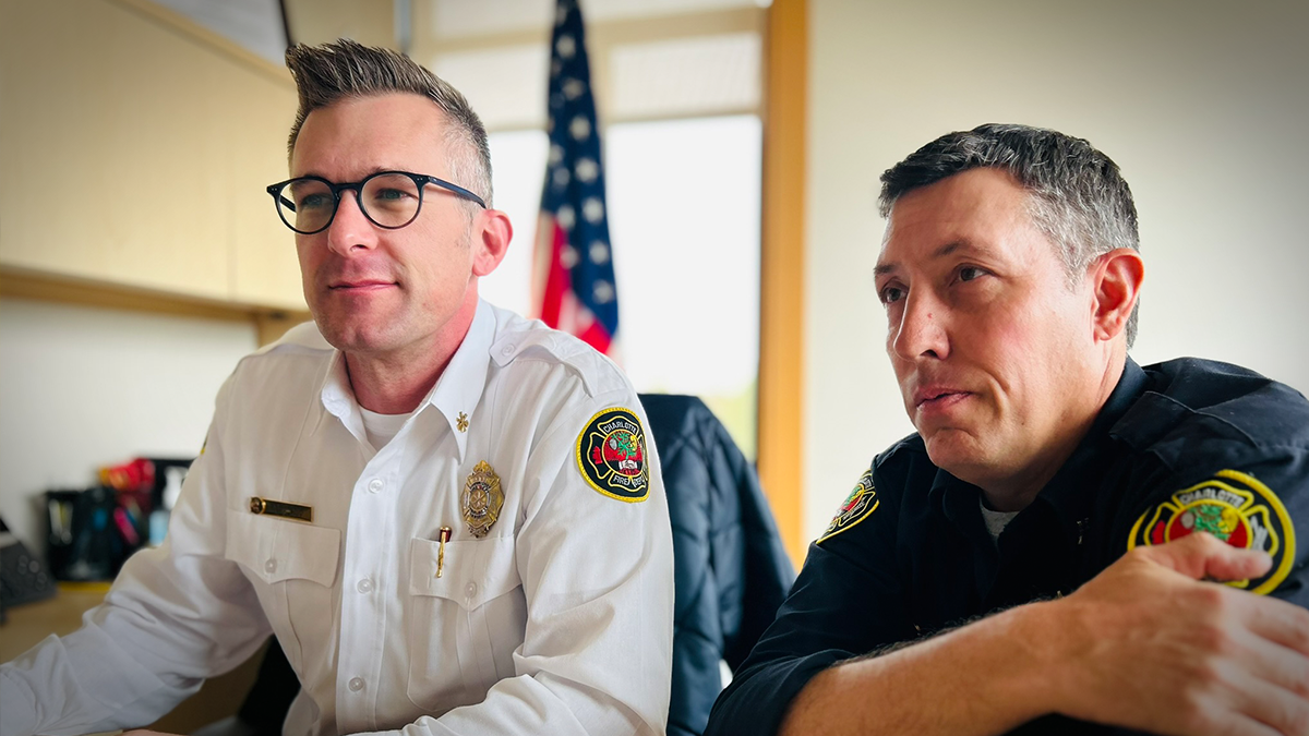 Field Technician Captain Drew Lazarus (right) and Division Chief Dave Farnum discuss strategic planning in the office. The Field Technician role is essential in preparing and supporting Chiefs, allowing for smoother and safer operations during emergency responses. 