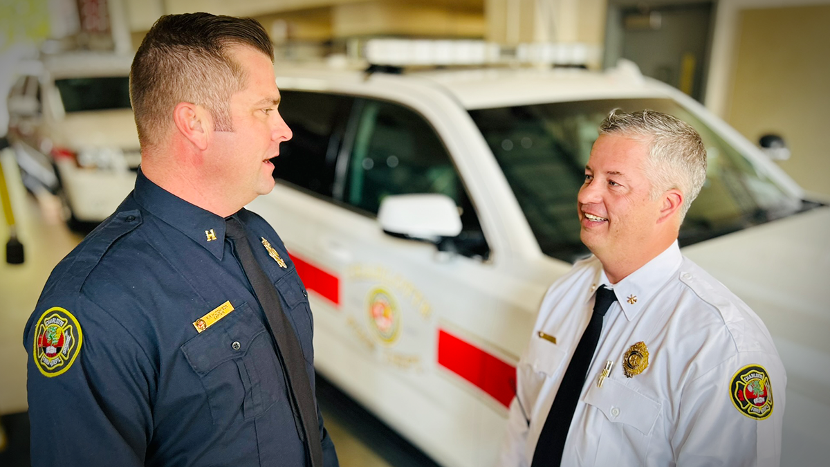 Field Technician Captain Robert Hutchison speaks with Division Chief Eric Withers inside the bay at Firehouse 1. Their collaboration underscores how the Field Technician program enhances on-the-ground coordination, ensuring that each incident is managed with precision from the outset. 