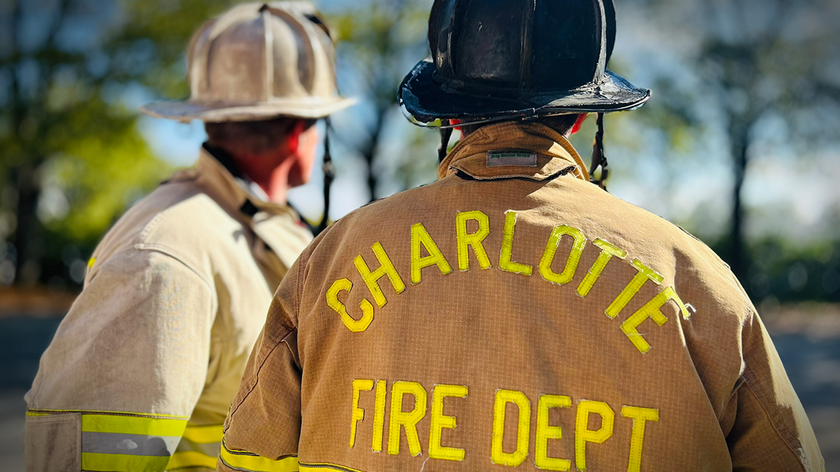 Captain Drew Lazarus and Division Chief Dave Farnum prepare together, highlighting the collaborative strength of Charlotte Fire's Field Technician program in supporting effective and safe operations.