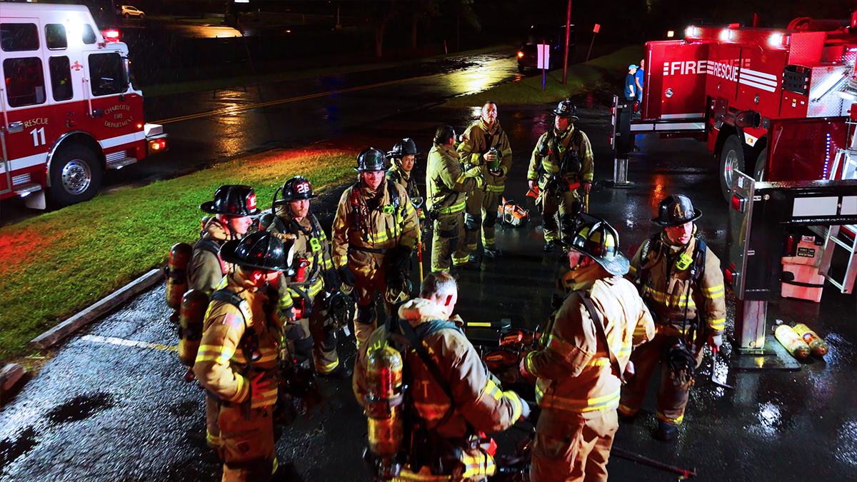 Firefighters conduct a debrief after a multi-unit fire response. Field Technicians are instrumental in coordinating these efforts, ensuring that teams are fully accounted for and equipped during critical operations. 