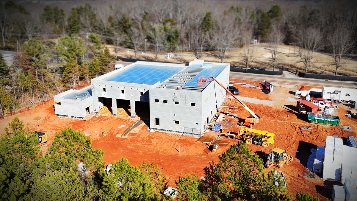 An aerial perspective of Firehouse 30 under construction, illustrating the building’s footprint and the bustling activity on-site. 