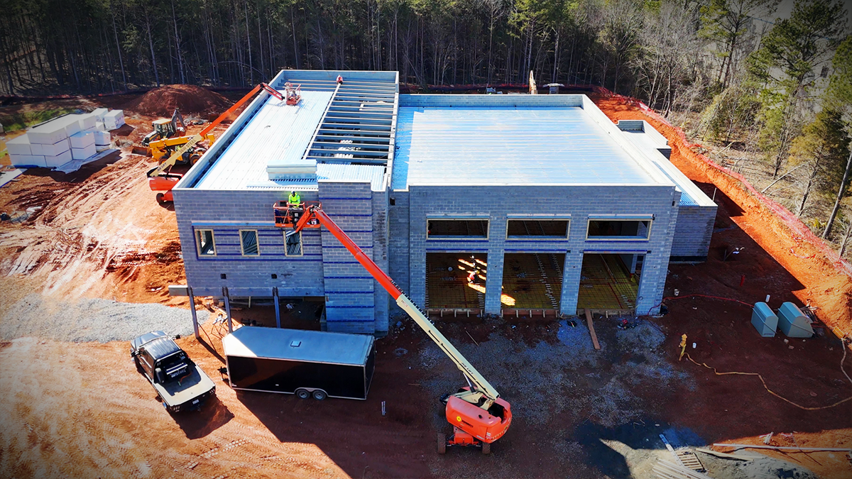 Construction crews working on the intricate framework of Firehouse 30’s exterior walls and roof. 