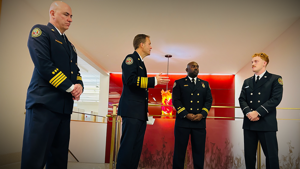 Gabriel Howard is joined by Charlotte Fire leaders before receiving his badge in a special ceremony. The event highlighted his resilience and dedication, as he missed his recruit class graduation to serve during Hurricane Helene. 