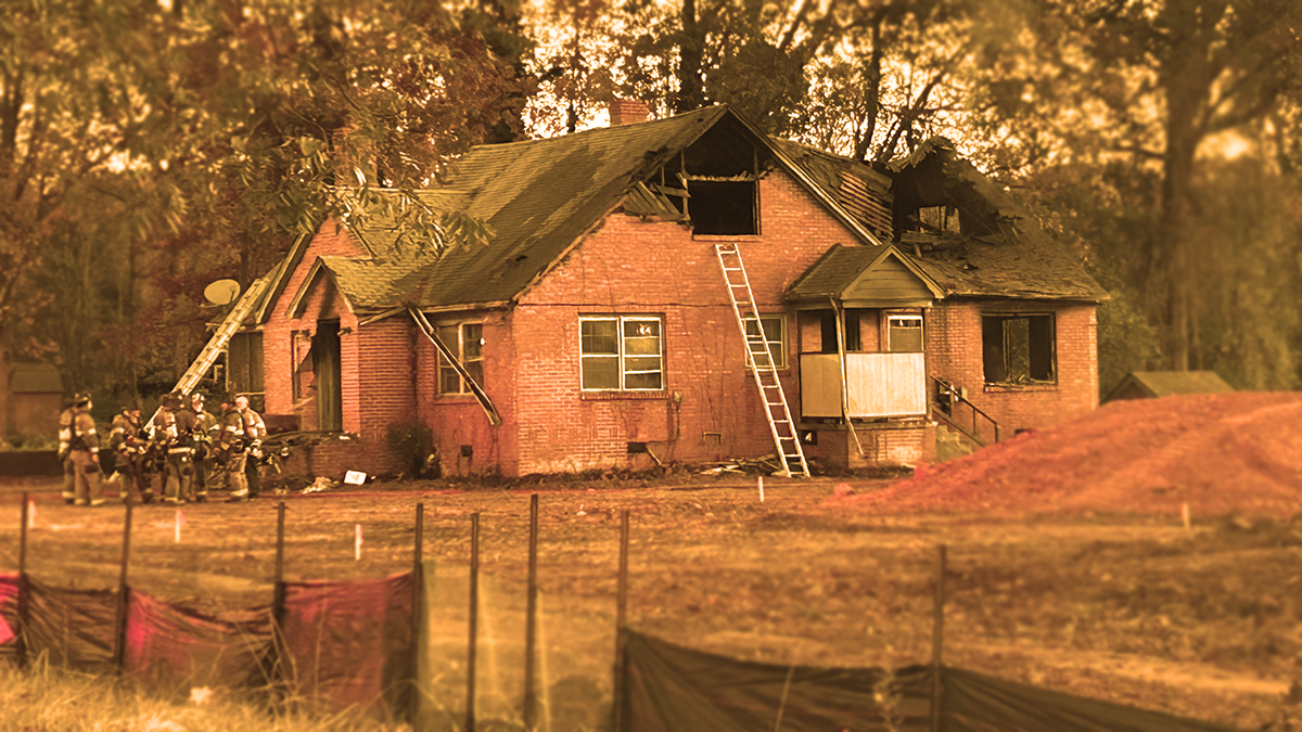 Aftermath of the fire with firefighters on scene assessing the damage.