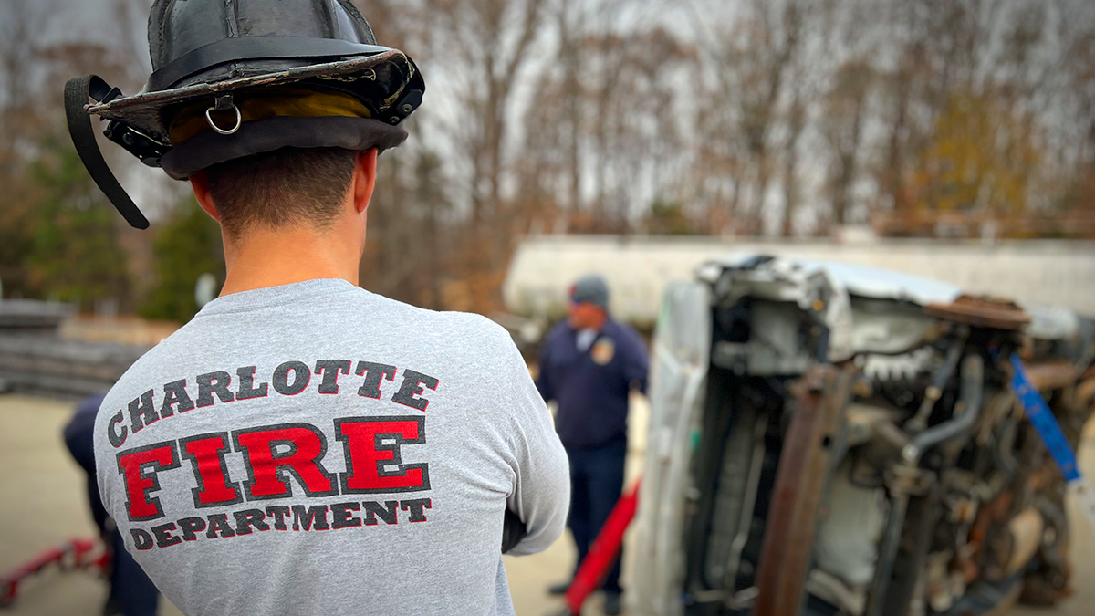 Charlotte Fire Ladder Company member observes a stabilization exercise during a rigorous training session focused on advanced rescue techniques.