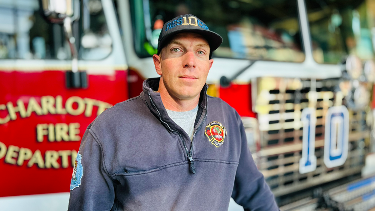 Firefighter Bell outside Rescue 10, showcasing the unity of the team who played a crucial role in the Ledger Court rescue.