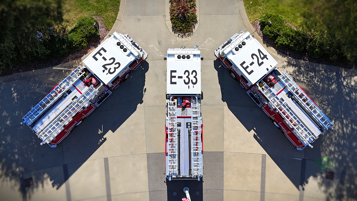 A top view of Charlotte Fire’s newest engines lined up at headquarters, showcasing their powerful and reliable design.