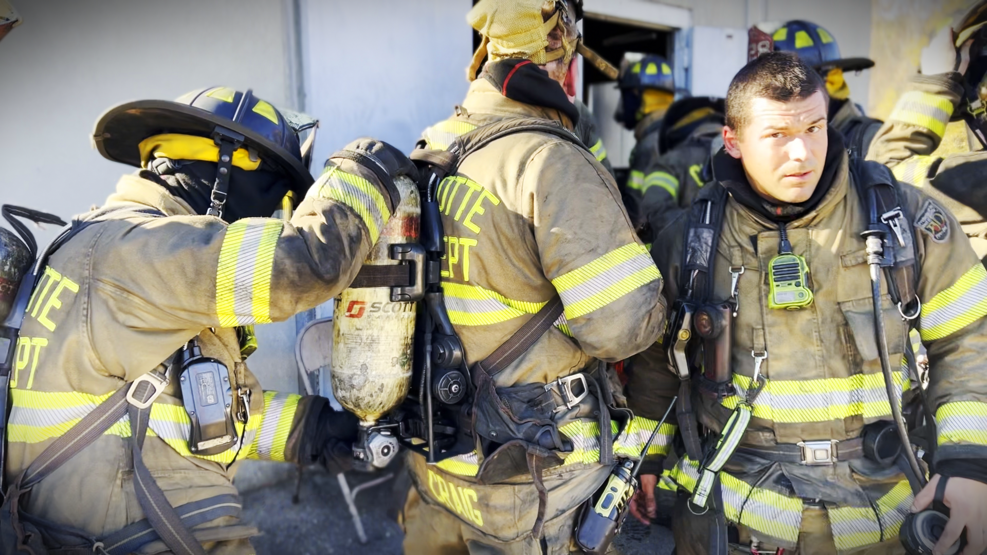 Charlotte Fire recruits exit a smoke-filled structure, reinforcing their training on survival techniques under intense, real-world conditions. 