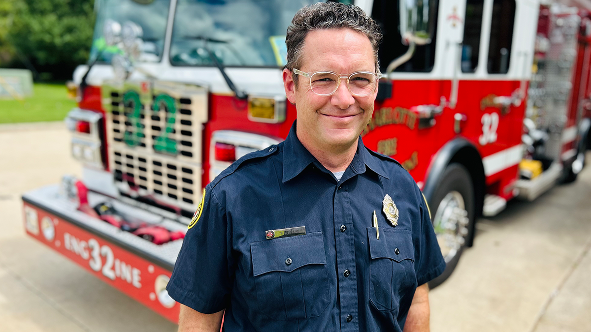 Engineer Shank in front of Engine 32 at Firehouse 32 