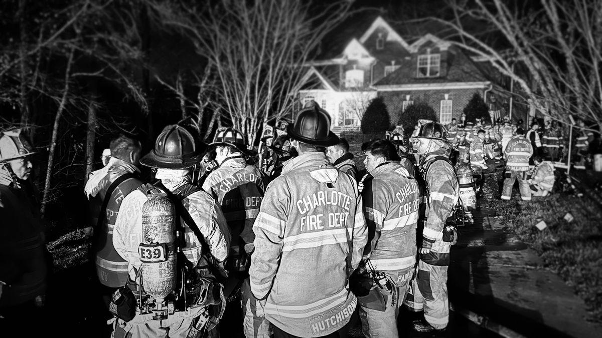 Charlotte Fire crews gather to debrief after extinguishing a two-alarm chimney fire on Callander Court. No injuries were reported, and the fire was controlled efficiently.