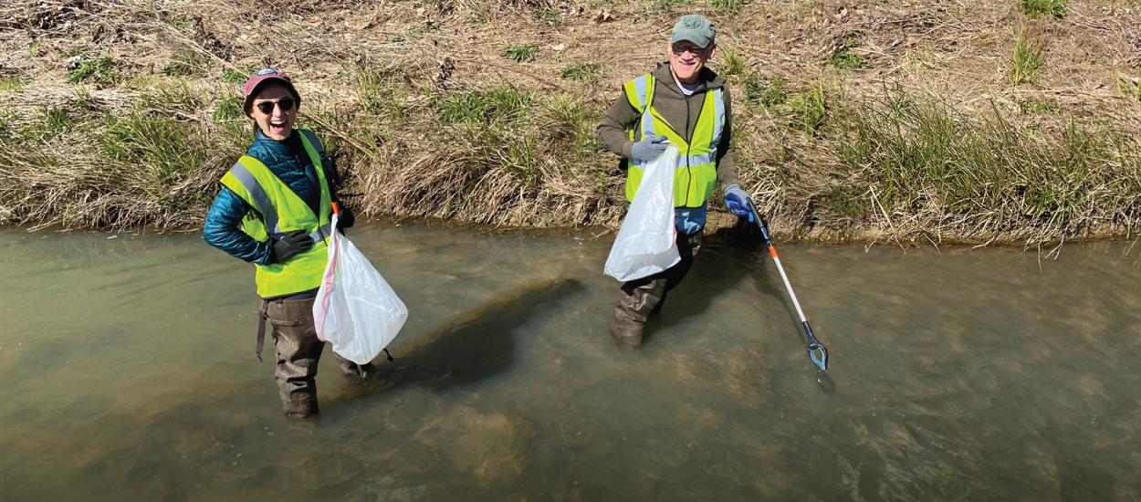 Volunteers cleaning up a creek in their community.