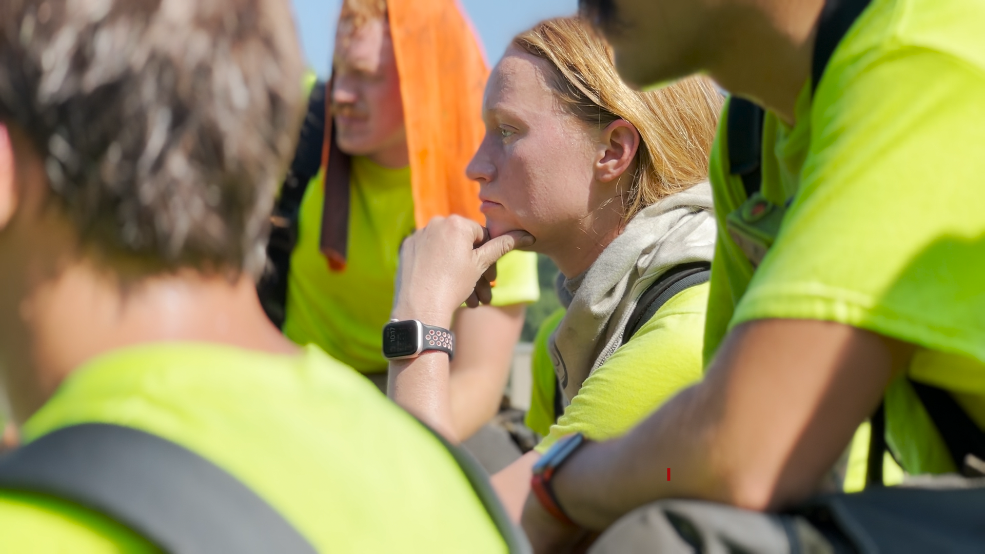 Gazerro rests her head on her hand while listening closely to training. She is framed by the blurry figures of other CFD recruits.