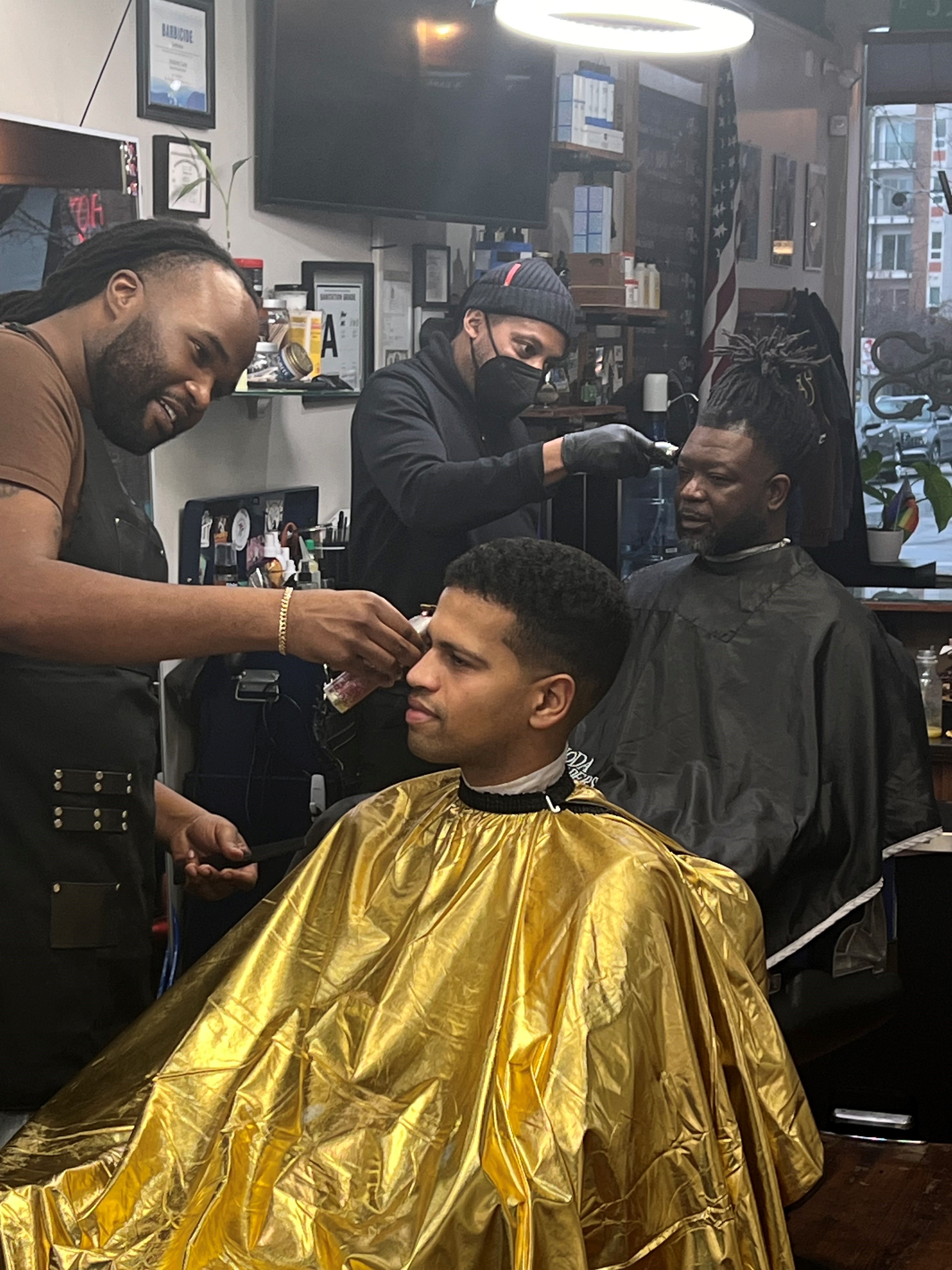 Clients being serviced at Noda Barbers.