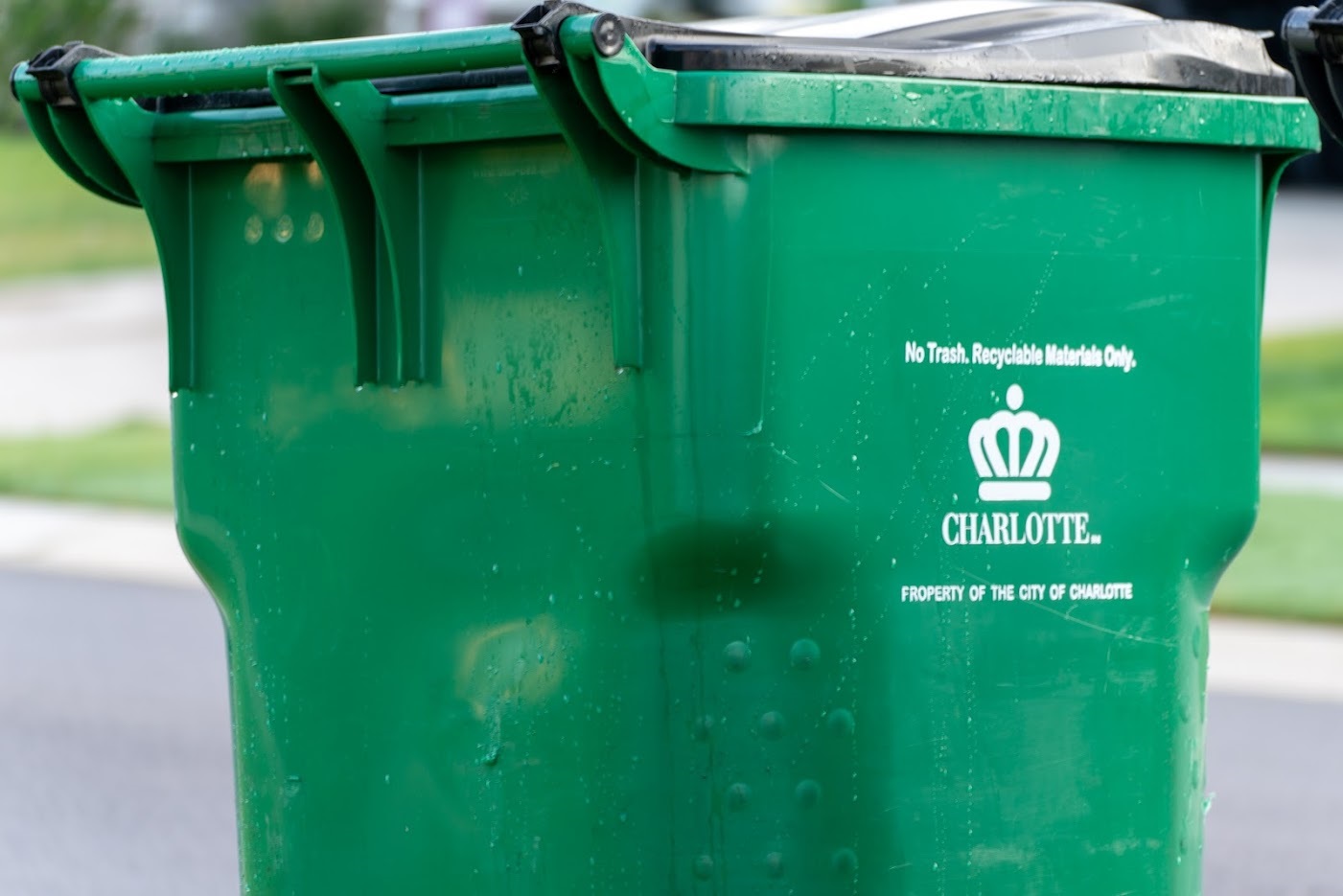 Close up of a green City of Charlotte recycling cart.