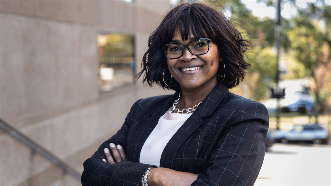 Assistant City Manager and Chief Information Officer Reenie Askew, standing with arms crossed and smiling.