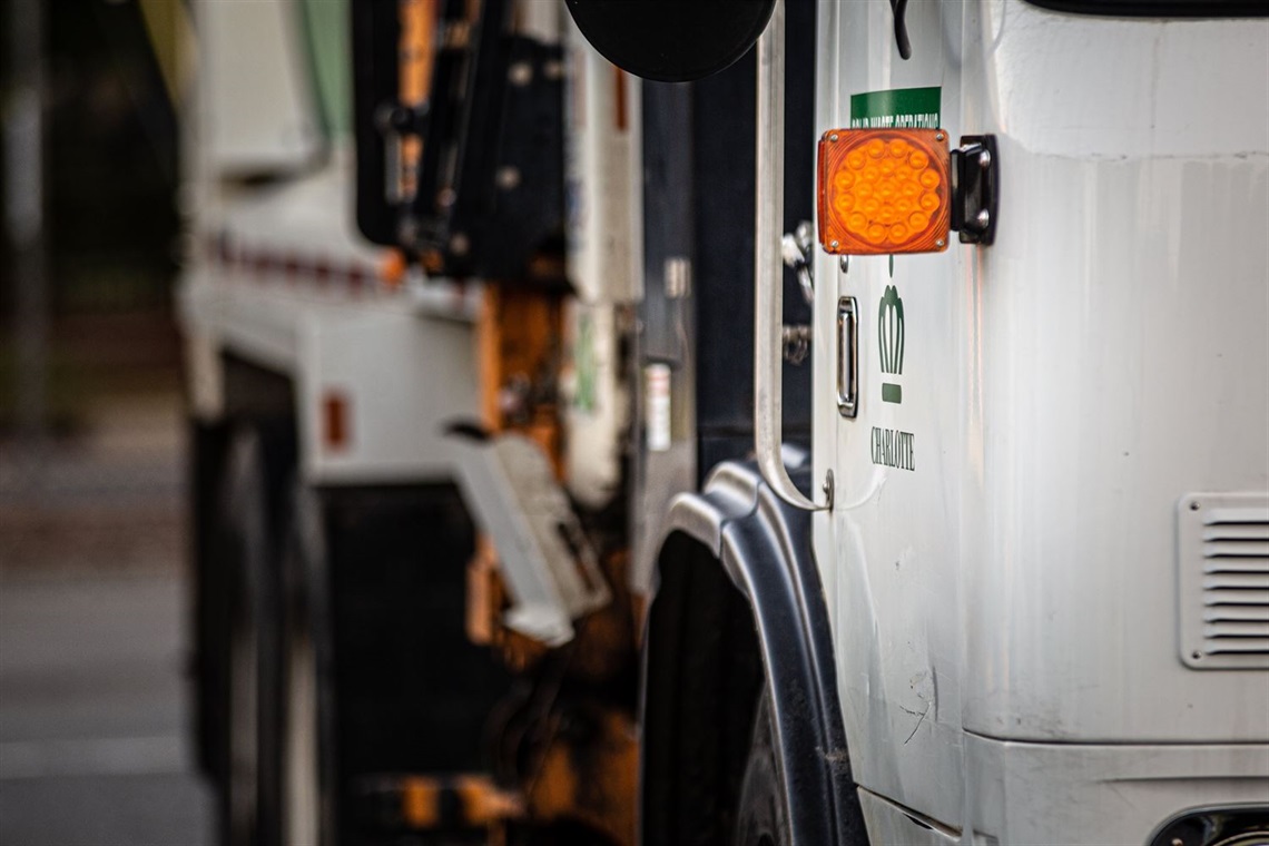 Close up on the exterior of a Solid Waste Services collection vehicle.