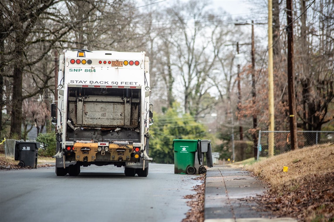 Solid Waste Services vehicle drives down a Charlotte road during collection. 