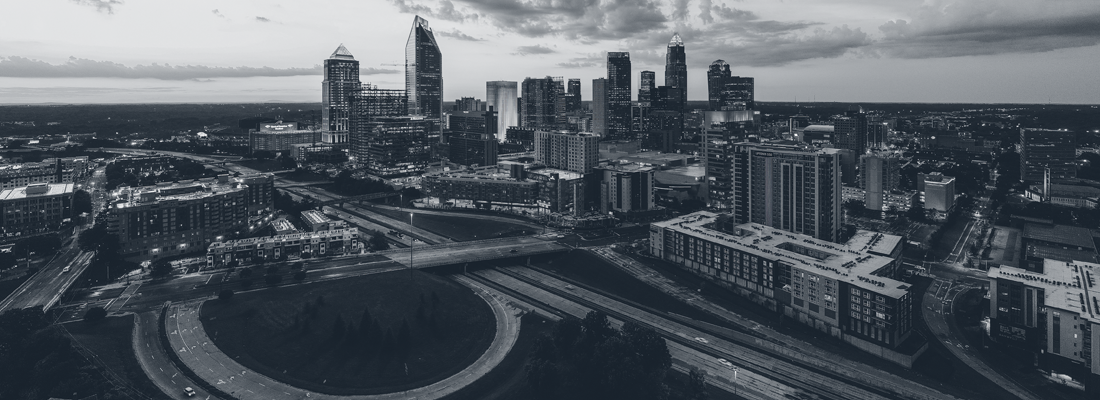 black and white aerial view of downtown Charlotte and nearby highway section